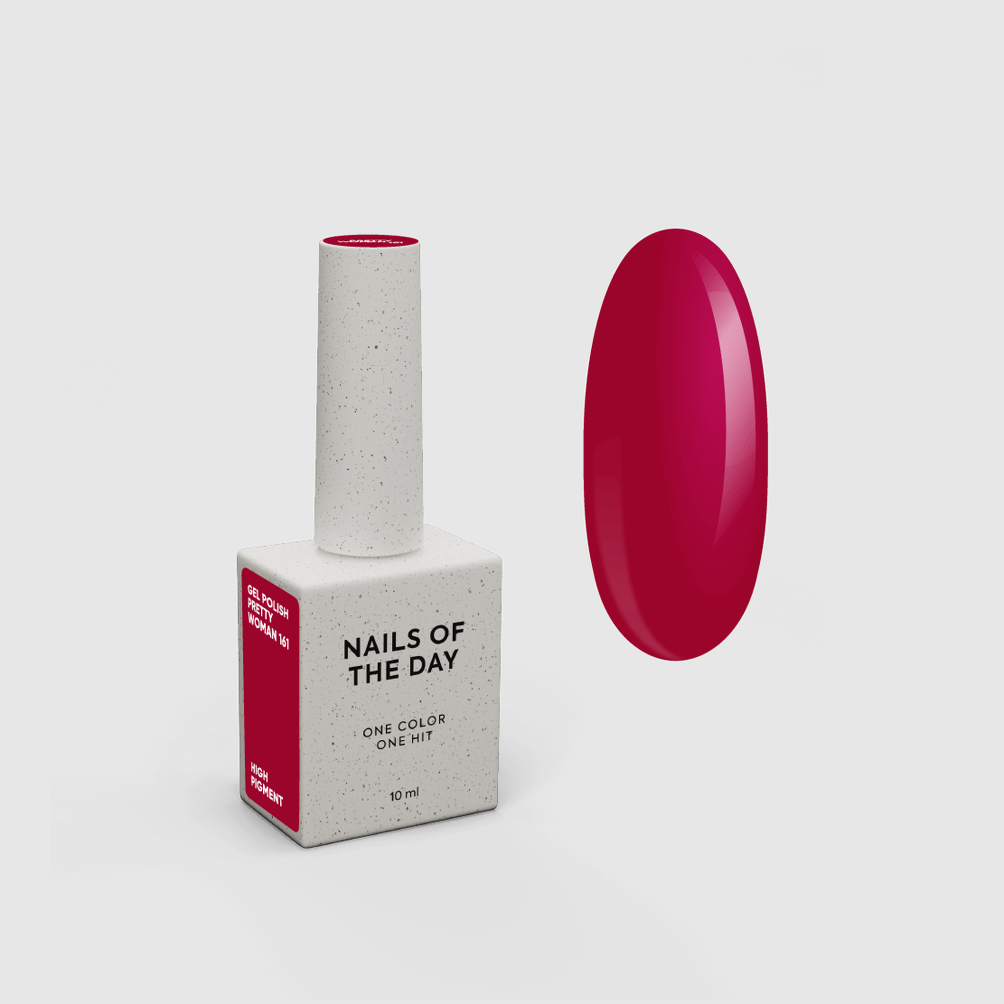 A bottle of nail polish with a white speckled cap and base, next to a glossy oval swatch showing the bright pink-red polish color. The base reads 'NAILS OF THE DAY' and 'ONE COLOR ONE HIT'.